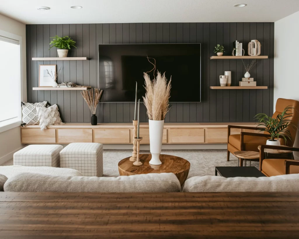 modern-rustic-living-room-with-black-wood-panel-accent-wall-and-floating-shelves.jpg